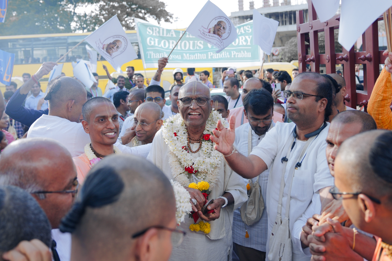 The Srila Prabhupāda mūrti being garlanded by senior devotees